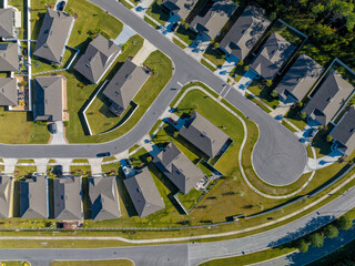 Aerial top view of typical American home development with asphalt road