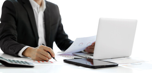 Businessman in suit writing business papers at desk in modern coworking office. copy space