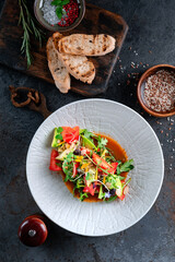 Italian salad with fresh vegetables. Mixed salad of tomatoes, cucumbers, avocado and greens