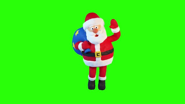 Plasticine Santa Claus with a bag walks and waves his hand in greeting. Animation with plasticine stop motion effect. Alpha channel.