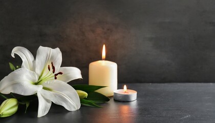 Obraz na płótnie Canvas Eternal Remembrance: Lily and Candle on Dark Background