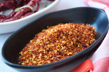 chili flakes in a bowl on table 