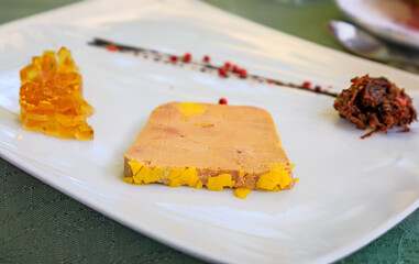 Traditional French mi cuit foie gras duck liver pate with white wine jelly and caramelized onions...