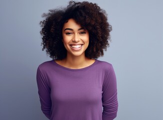 Smiling black woman with curly hair looking at camera