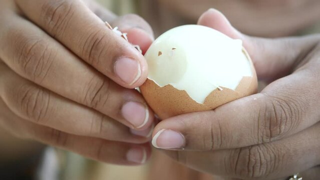 women hand perfectly Peeled Boiled Eggs 