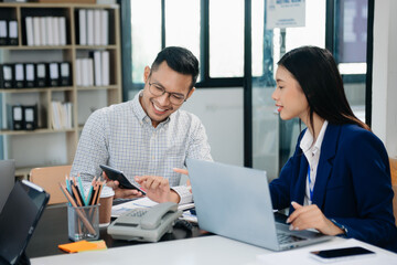 Group of young Asian business people discussing business plan at startup in office