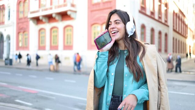 Young woman is listening to music and enjoying the outdoors