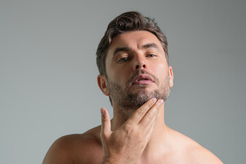 Obraz premium Male beauty. Cream treatment for male face. Beauty routine. Face of a beautiful man with perfect skin. Anti-aging and wrinkle cream. Concept of male beauty. Male skincare cosmetics concept. Skin care.