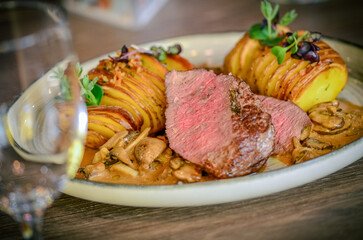 Juicy steak with baked potatoes and mushrooms, Dry aged prime grade beef rib eye steak cooked medium rare. 