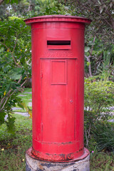 Fototapeta na wymiar Traditional red mail letter box, London UK style. Symbols of the city and England. Classic old red post box for sent letter in retro city background. Vintage postbox, English crown icon design