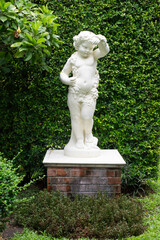 Beautiful little angel statue in the garden. Marble statue monument english design for garden...