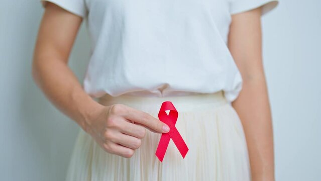 woman with Red Ribbon for December World Aids Day, acquired immune deficiency syndrome, Sexual Transmitted diseases, Syphilis, Chancroid, Genital Herpes, Gonorrhea, Healthcare and world cancer day