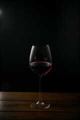 glass of red wine on black
