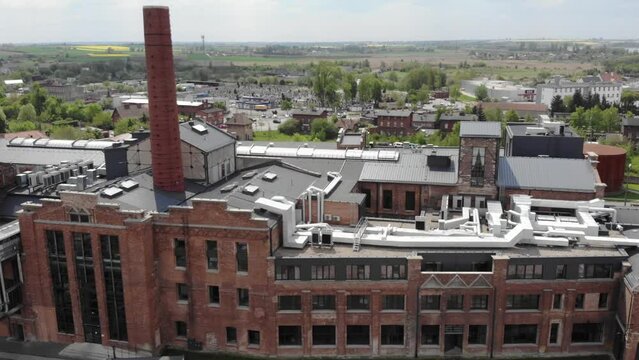 Facade Of Hotel Building With Smokestack. Former Sugar Factory In Znin, Poland. aerial