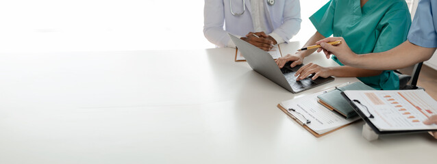 A group of doctors meets together to solve the problem of the epidemic, There was a meeting about major surgery in the hospital, The doctor takes the patient's documents and discusses them with team.