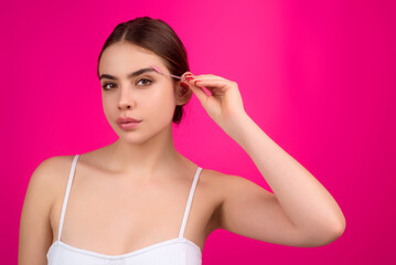 Beautiful woman with dark eyebrows hold eyebrow brush. Eyebrows lamination. Brow beauty procedures....