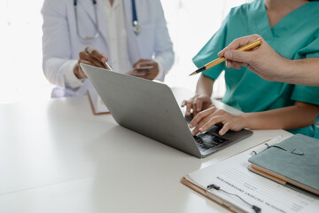 A group of doctors meets together to solve the problem of the epidemic, There was a meeting about major surgery in the hospital, The doctor takes the patient's documents and discusses them with team.