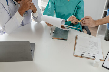 A group of doctors meets together to solve the problem of the epidemic, There was a meeting about major surgery in the hospital, The doctor takes the patient's documents and discusses them with team.