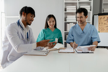 A group of male and female doctors sat and talked about the patient's history, There was a meeting about major surgery, The doctor takes the patient's documents and discusses them with team.