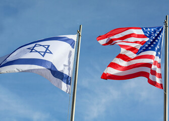two large Israeli and American flags flying in the sky