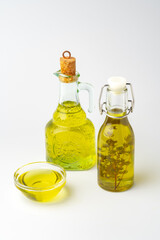 Bottles of two cooking oils on white background