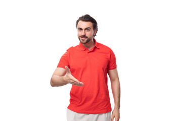young brutal caucasian brunette man with a beard dressed in red clothes on a studio background with copy space