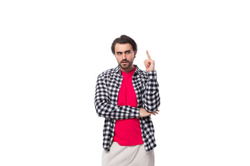 portrait of a young handsome brunette caucasian man with a beard dressed in a plaid shirt on a white background