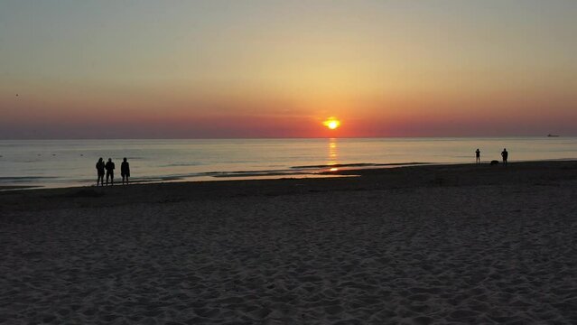 Drone shot, drone flight over the beach with people, the North Sea coast and the North Sea towards the sunset, Julianadorp, North Holland, Den Helder, Netherlands