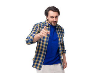 Fototapeta premium portrait of a pleasant calm young european brunette with a beard dressed stylishly in a shirt