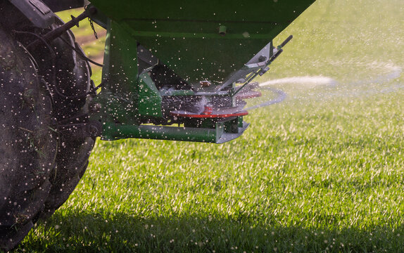 tractor fertilizing in field