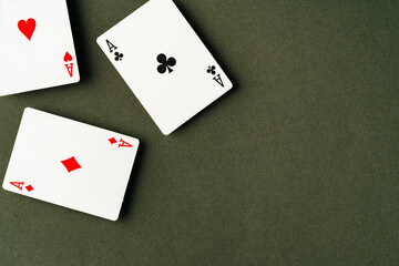 Playing cards on green background studio shot