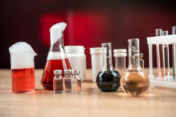 Obraz na płótnie Canvas Science experiment laboratory flasks with different multi-colored liquids on desk