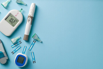 Top view of glucometer, lancet pen and strips on blue background. diabetes test kit - obrazy, fototapety, plakaty