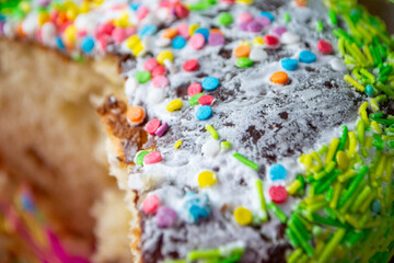 Traditional easter holiday table served with homemade easter cake . A cake with sprinkles on it is...
