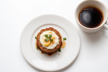 food on a white plate on table with coffee