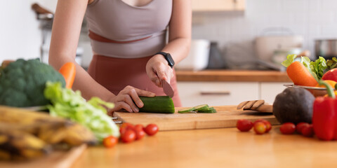 Young Asian healthy beautiful woman with casual clothes is smile and slicing fresh fruit to diet at home in kitchen in holiday