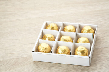 Chocolate candies with dates fruit filling in a box. Gifts festive food love concept.
