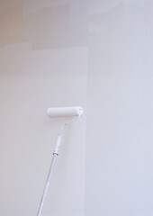 Long handle Roller Brush Painting White Primer color on cement house wall in Vertical frame, Home...