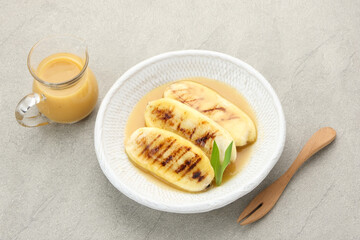 Pisang Gapit or Pisang Epe, grilled banana with palm sugar sauce. Indonesian traditional food.

