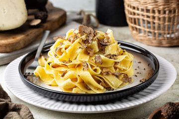 Black Truffle fettuccine with mushrooms, long egg pasta. Italian first course made with hard cheese...