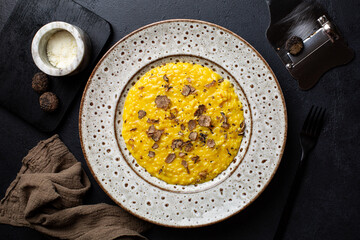 Saffron risotto with delicious black truffles and hard cheese. Tuber Aestivum with special slider...