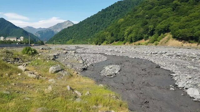 Muddy River Water Flowing in Landscape of Azerbaijan on Sunny Summer Day
