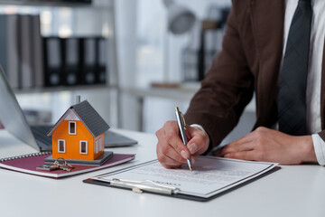 Fototapeta na wymiar Signing home sales and insurance contracts with real estate agents, signing contracts to know the terms of buying and selling homes and real estate, contract signing ideas.