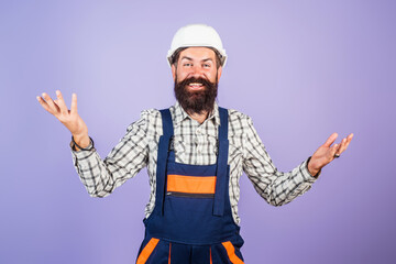 Man in helmet, builder with building equipment and hardhat. Safety helmet. Renovation. Man in hardhat. Heavy work. Builder working. Hard job. Construction man, worker contractor foreman workman.