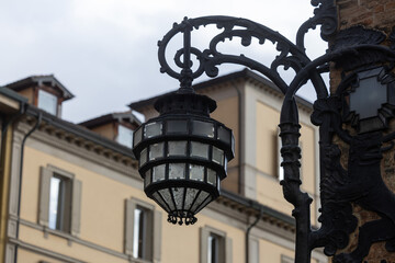 Fototapeta na wymiar Old wall street lighting in the old town of Bologna. Italy