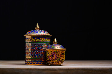 Authentic Thai Benjarong porcelain with vibrant jewel-toned patterns and gold embellishments,...