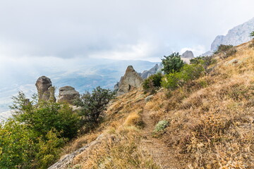 Fototapeta premium Mysterious mountain landscape of the Valley of Ghosts, a cluster of strangely shaped rocks on the western slope of Mount Demerdzhi in Crimea