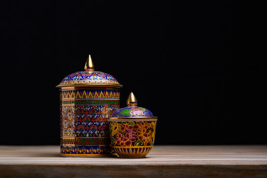 Authentic Thai Benjarong porcelain with vibrant jewel-toned patterns and gold embellishments, representing the richness of Thai cultural craftsmanship.