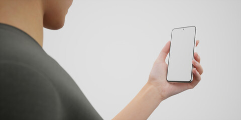 Caucasian woman holding phone on a white background, blank screen mockup