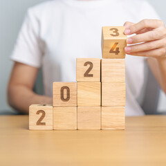 2024 wood block with business goal, success, strategy, target, mission, action, growth, teamwork,...